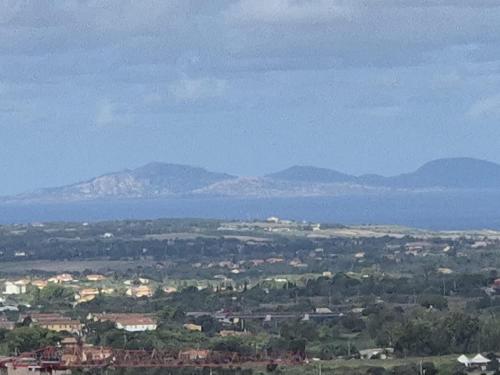 a view of a city with mountains in the distance at La terrazza di Anna in Sassari