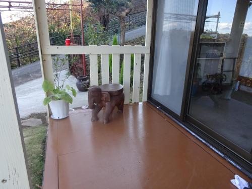 a statue of a dog sitting on a porch at Tabiposuto Nonohana - Vacation STAY 89263v in Ito