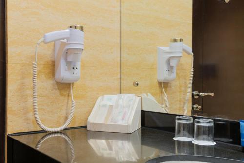 a phone on a wall next to a sink at Four Points by Sheraton Medan in Medan