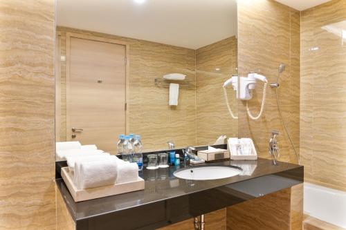 a bathroom with a sink and a shower at Four Points by Sheraton Medan in Medan