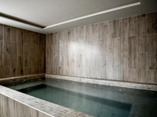 a pool of water in a room with a wall at Les Trois Vallées, a Beaumier hotel in Courchevel