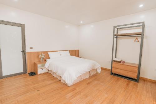 a bedroom with a large bed and a mirror at Sunny Camping Sóc Sơn in Sóc Sơn