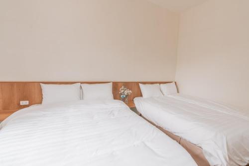 two beds sitting next to each other in a bedroom at Sunny Camping Sóc Sơn in Sóc Sơn