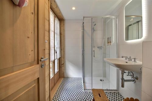 a bathroom with a sink and a shower at Chalet Eden, 4 Story Family Chalet in Champéry