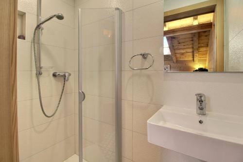 a bathroom with a shower and a sink at Chalet Eden, 4 Story Family Chalet in Champéry