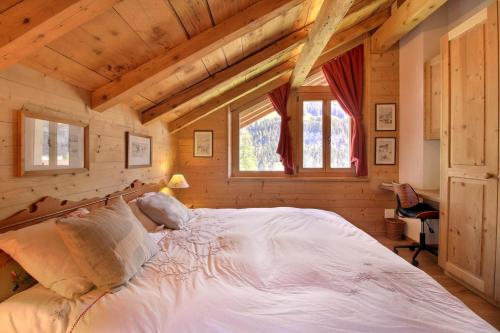 a bedroom with a large bed in a log cabin at Chalet Eden, 4 Story Family Chalet in Champéry