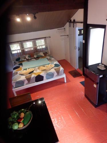 a bedroom with a bed and a bowl of fruit on the floor at Koh Mak 7 in Ko Mak