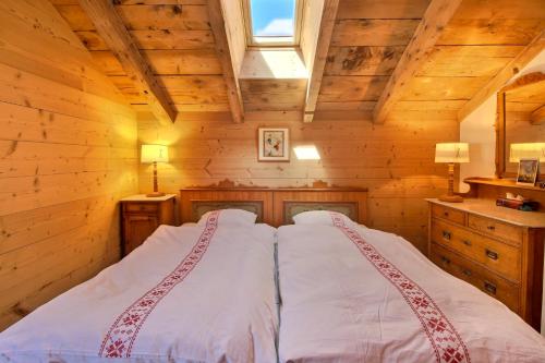a bedroom with two beds in a log cabin at Chalet Eden, 4 Story Family Chalet in Champéry