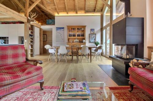 a living room with a couch and a table at Chalet Eden, 4 Story Family Chalet in Champéry