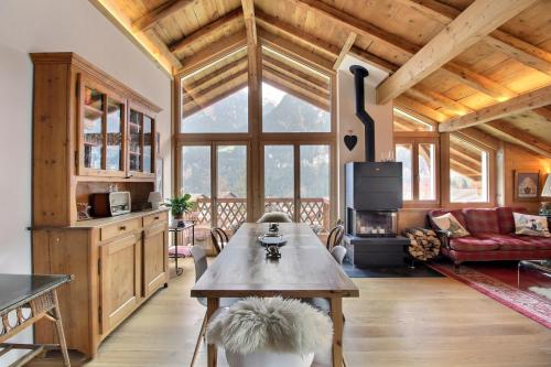 a living room with a table and a couch at Chalet Eden, 4 Story Family Chalet in Champéry