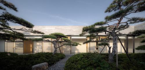 a building with trees in front of it at 徐州云东境酒店 in Xuzhou