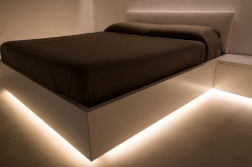 a bedroom with a bed with lights on it at Solo per Noi Apartment in Siena