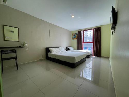 a hotel room with a bed and a window at Parc Hotel Pelangi Damansara in Kuala Lumpur
