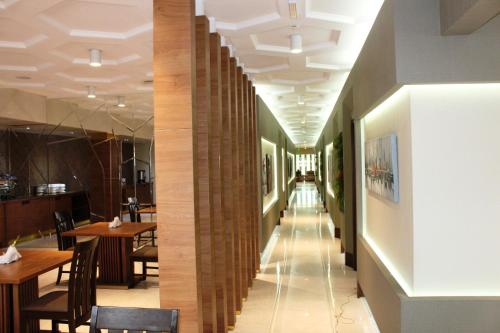 a corridor of a restaurant with tables and chairs at Hotel Panorama Gareji in Sagarejo