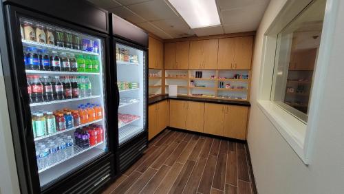 a refrigerator filled with lots of sodas and drinks at Holiday Inn Express Fayetteville Fort Bragg by IHG in Fayetteville