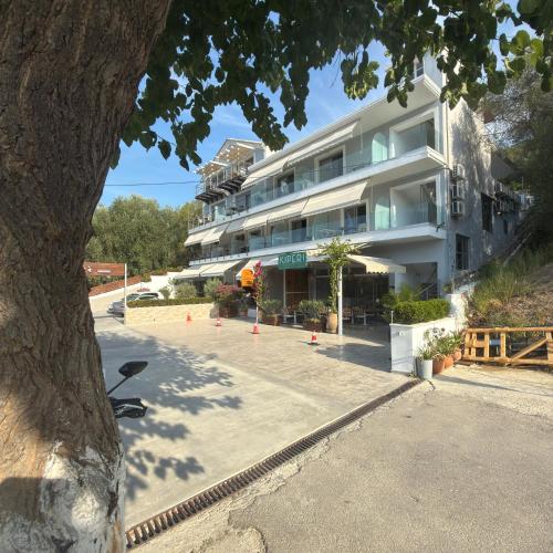 a large white building with orange cones in front of it at Kiperi Exclusive in Parga