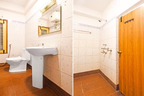 a bathroom with a toilet and a sink at Super Townhouse Hill Cart Road Siliguri in Siliguri