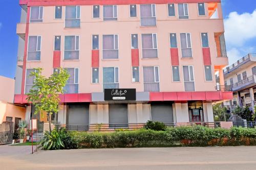 a tall pink building with a sign in front of it at Super Collection O Sunder Nagar Golvyas Formerly Hotel Vanshil in Jaipur