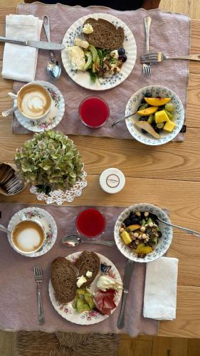 a wooden table with plates of food on it at Tenuta Agriturismo La Borina in San Bonifacio