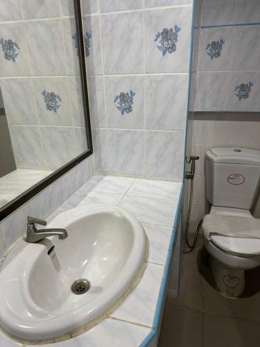 a bathroom with a sink and a toilet at Blue Garden Resort Pattaya in Jomtien Beach