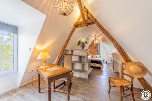 a home office with a desk and a staircase at Le logis du cliquet in Thibivillers