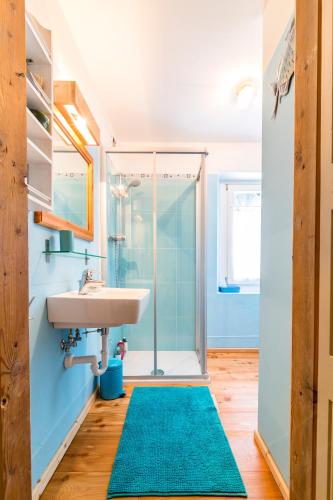 a bathroom with a sink and a shower at La Casa dei Botiri in Rocca Pietore