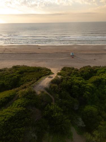 an aerial view of a beach with the ocean at Terrazas Ostende - Apart Hotel in Ostende