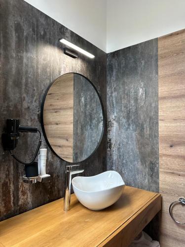 a bathroom with a sink and a mirror at Altfel Bran Chalet 2 in Bran