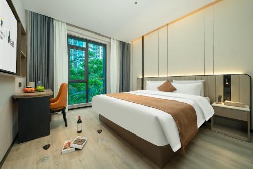 a hotel room with a large bed and a window at Rezen Borui Hotel Guangzhou Tower Sun Yat-sen University Branch in Guangzhou