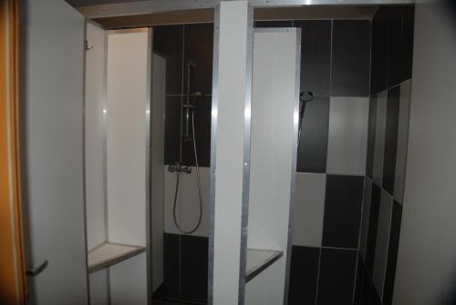 a bathroom with a shower and a glass door at Weinberg Bikercamp in Höch