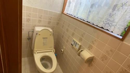 a small bathroom with a toilet and a window at 一宿一景一生縁-千葉県市原市小谷田店 in Ichihara