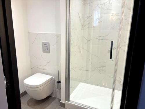 a bathroom with a toilet and a shower at Campanile Reims Centre - Cathedrale in Reims