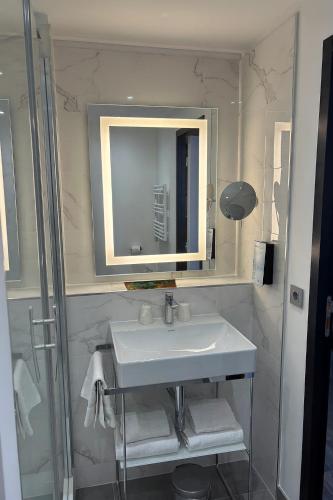 a bathroom with a sink and a mirror at Campanile Reims Centre - Cathedrale in Reims