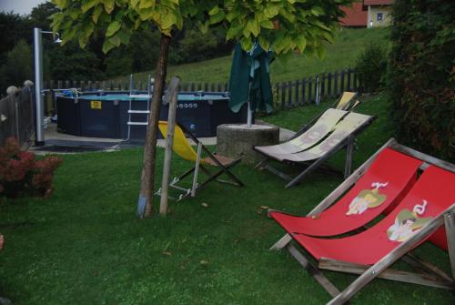 a group of chairs sitting on the grass in a yard at Weinberg Bikercamp in Höch