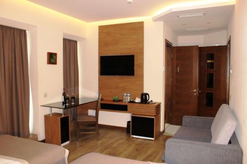 a living room with a desk and a couch at Hotel Panorama Gareji in Sagarejo