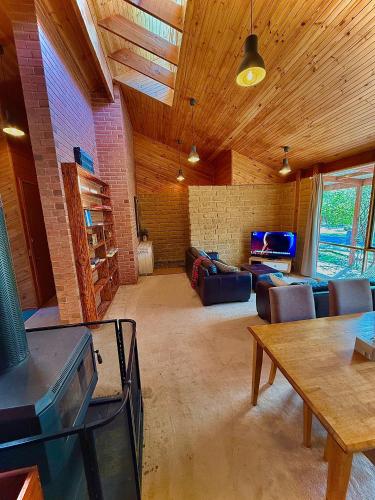 a living room with a couch and a table at Grampians Bush Retreat in Halls Gap