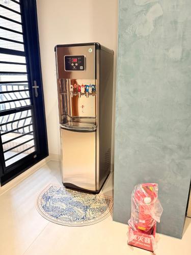 a refrigerator is sitting in a room at 東港民宿 - 如你所院 Tourist Vacation B&B in Donggang