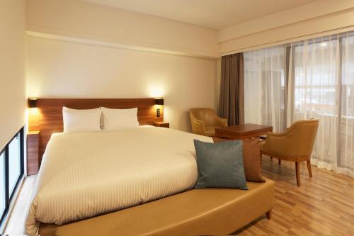 a hotel room with a bed and a desk at Sakura Terrace The Gallery in Kyoto
