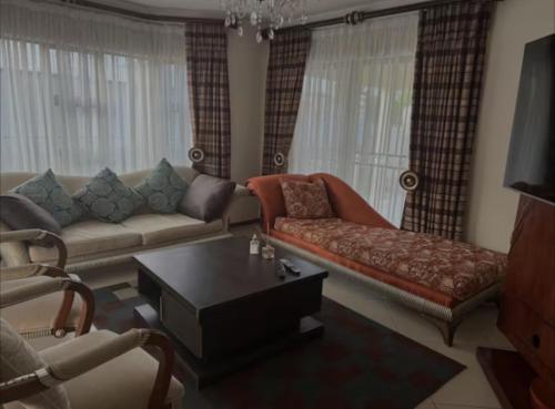 a living room with a couch and a coffee table at P & S Executive Home in Maseru