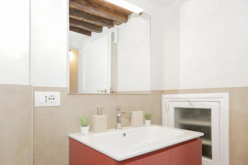 a bathroom with a sink and a mirror at Ca' du Pitta in Genova
