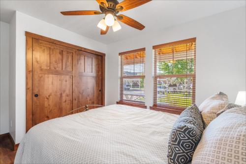 a bedroom with a ceiling fan and a bed with pillows at Dover Bay in Dover