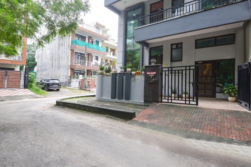 a house with a gate on the side of a street at FabHotel Golf Luxury in Gurgaon