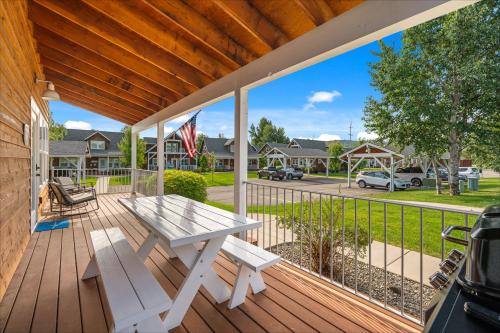 a porch with a white picnic table and a grill at Dover Bay in Dover