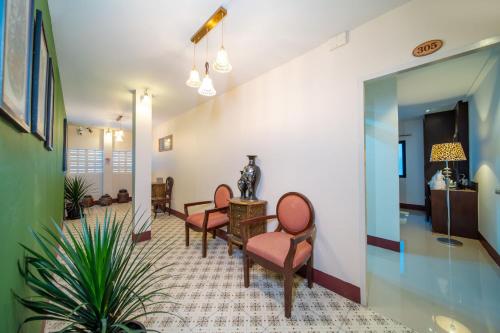 a waiting room with two chairs and a table at Nyonya Maison Boutique Hotel Phuket Old Town in Phuket Town