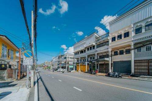 an empty street in a city with buildings at Nyonya Maison Boutique Hotel Phuket Old Town in Phuket Town