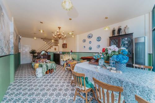 a dining room with a table and chairs at Nyonya Maison Boutique Hotel Phuket Old Town in Phuket Town