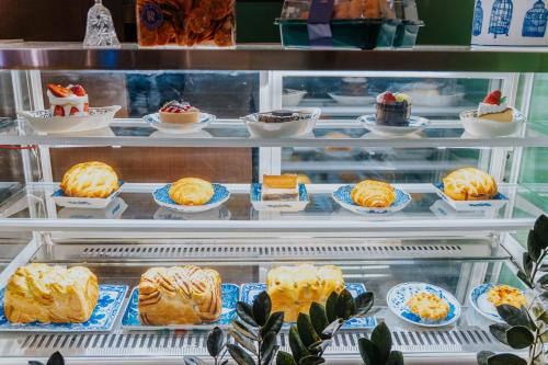 a refrigerator filled with different types of desserts at Nyonya Maison Boutique Hotel Phuket Old Town in Phuket Town
