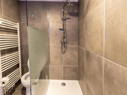 a bathroom with a shower and a toilet at Duplex Apartment in the shopping street of Maasmechelen in Maasmechelen