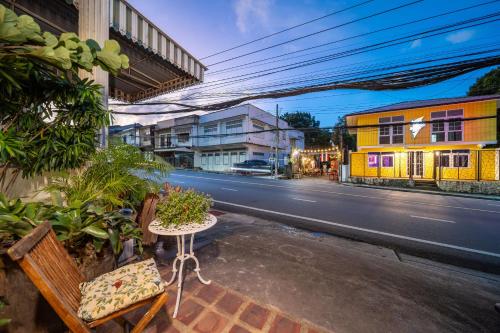 a table and chairs on the side of a street at Nyonya Maison Boutique Hotel Phuket Old Town in Phuket Town