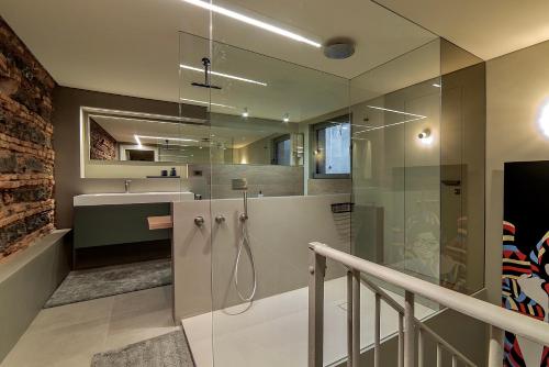 a bathroom with a glass shower and a sink at Luxury apartment in the center of Catania in Catania